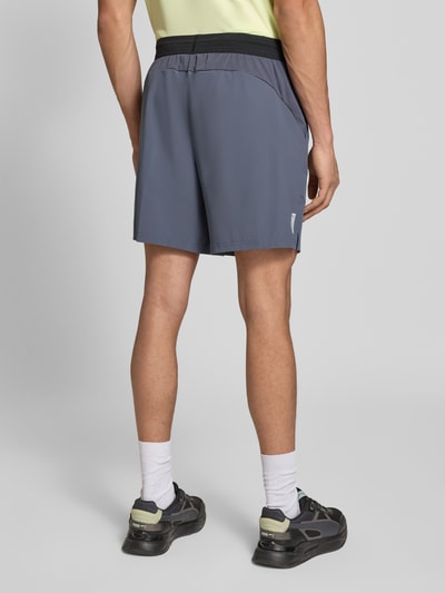 Männermodel trägt Shorts mit elastischem Bund und Logo von PUMA PERFORMANCE, Material-Mix mit Stretch-Anteil, Regular-Fit, Rückansicht.
