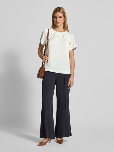 Frauenmodel trägt Relaxed Fit Bluse mit gelegten Falten von Comma, Satin, Kurzärmelig, Elastischer-Material-Mix, Rundhalsausschnitt, Ganzkörperansicht von vorne.