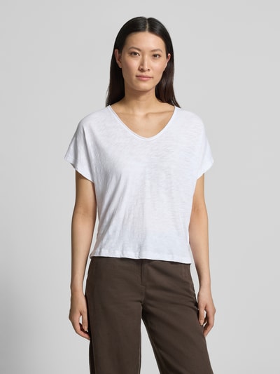 Frauenmodel trägt Regular Fit T-Shirt aus reiner Baumwolle von Marc O'Polo in Weiß, Melange-Optik, kurzarm, V-Ausschnitt, Label Patch, Ganzkörperansicht von vorne.