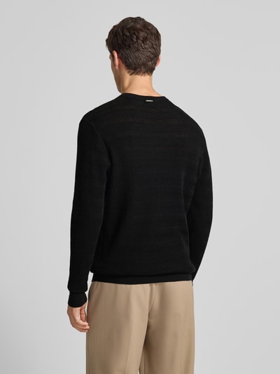 Männermodel trägt Regular Fit Strickpullover mit Rundhalsausschnitt von Antony Morato in Schwarz, Strukturmuster, Rückansicht, Ganzkörperansicht.