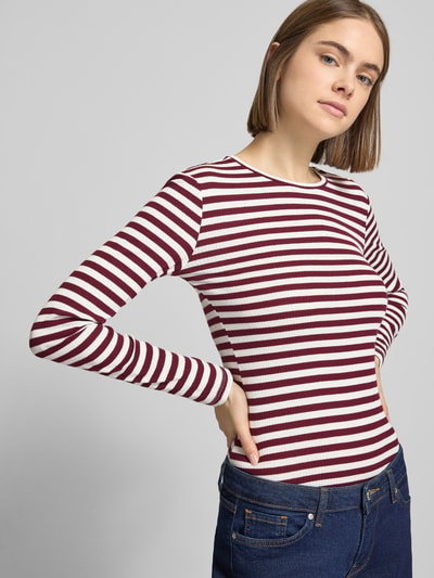 Frauenmodel trägt gestreiftes Slim Fit Langarmshirt aus Baumwoll-Mix von Pieces, Two Tone, unifarben, Rippstrick, Rundhals, Ganzkörperansicht von vorne.