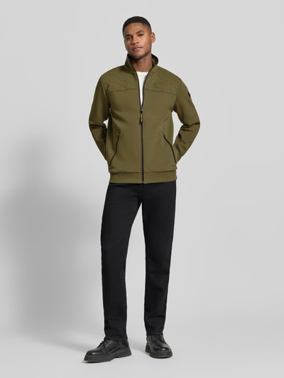Męski model nosi Sweatjacke mit Reißverschluss od PME Legend, zielony, prosty krój, stójka, bawełniany mix, detale z logo, długość tyłu 72 cm, długość rękawa 67 cm, zamki, ściągacze, widok całej sylwetki z przodu.
