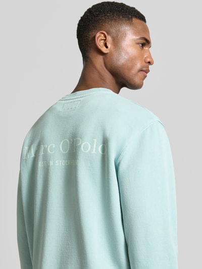 Männermodel trägt Regular Fit Sweatjacke aus reiner Baumwolle von Marc O'Polo, unifarben, Label Print, Sweatstoff, Nahaufnahme Oberkörper Rückansicht.