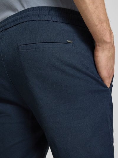 Männermodel trägt Regular Fit Bermudas aus Baumwoll-Leinen-Mix Modell 'LINUS' von Only & Sons, unifarben, Nahaufnahme Rückansicht.