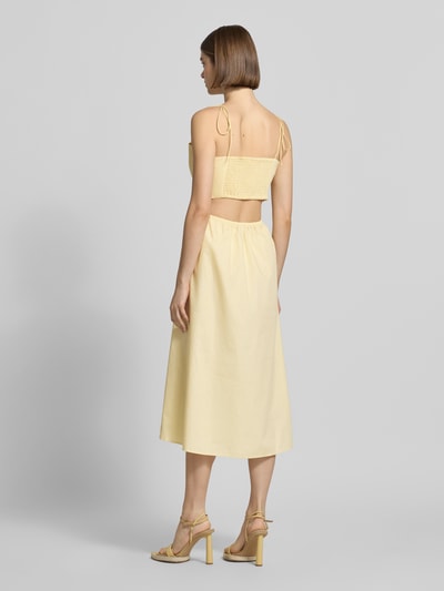 Frauenmodel trägt Midikleid mit Cut-Out Modell 'Tela' von LeGer by Lena Gercke in Gelb aus Reine Baumwolle, Taillierte Passform, Spaghetti-Träger, Rückenlänge bei Größe 36: 109 cm, Brustweite bei Größe 36: 39 cm, Ganzkörperansicht Rückansicht.
