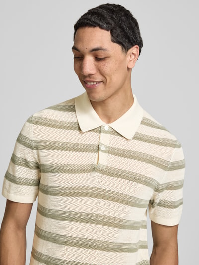 Männermodel trägt Regular Fit Poloshirt aus reiner Baumwolle von Pepe Jeans mit Optik:Allover-Muster, Strick, Label-Patch, Nahaufnahme Oberkörper.