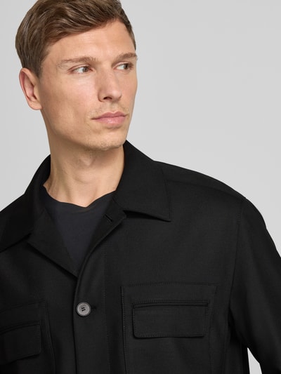 Männermodel trägt Regular Fit Hemdjacke mit Viskose-Anteil Modell 'JULIANO' von HUGO, unifarben, Label-Print, Nahaufnahme Oberkörper.