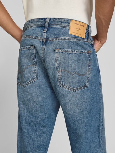 Męski model nosi Straight Fit Jeans aus reiner Baumwolle Modell 'ALEX' od JACK & JONES, 5 kieszeni, niebieski denim, zapięcie na guzik i zamek błyskawiczny, Szerokość w rozmiarze 32/32: 39 cm, Długość wewnętrzna nogawki: 73 cm, widok całej sylwetki z tyłu.