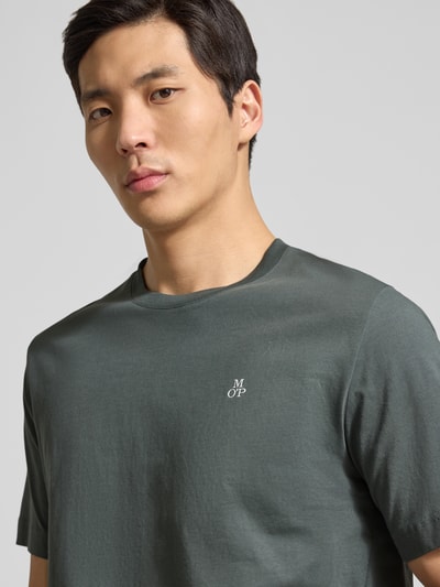 Männermodel trägt Regular Fit T-Shirt aus reiner Baumwolle von Marc O'Polo in Unifarbe mit Logo-Stitching, Nahaufnahme Oberkörper.