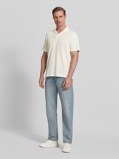 Männermodel trägt Relaxed Fit Poloshirt aus Baumwoll-Mix von Tom Tailor Denim, Optik: Unifarben, Piqué-Struktur, Ganzkörperansicht von vorne.