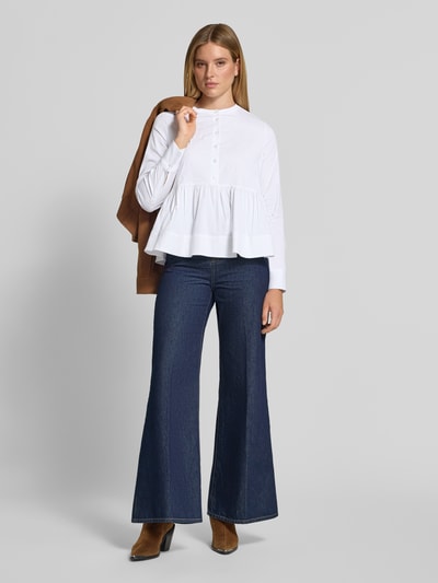 Frauenmodel trägt Regular Fit Bluse mit Knopfleiste von Milano Italy, weiß, Rüschen, Langarm, Jeans, Ganzkörperansicht von vorne. Damen Bluse, Rundhalsausschnitt, Rückenlänge 62 cm, Ärmellänge 61 cm.