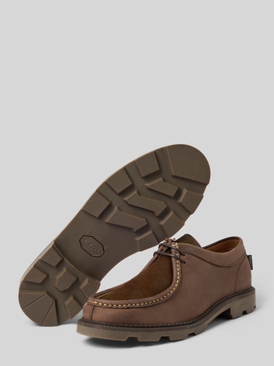 Produktfoto, Bootsschuhe mit Label-Detail Modell 'LATYMER' von POMPEII BRAND, beschichtetes Leder, abgerundete Form, Schnürung, profilierte Sohle, braune Farbgebung, Absatzhöhe 3 cm, Schafthöhe 7 cm, Schaftweite 10 cm, strukturierte Textur und Kontrastnähte auf grauem Hintergrund.