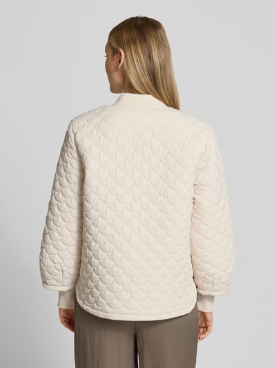 Vrouwenmodel draagt Regular Fit Steppjacke met Eingrifftaschen Modell 'Bingo' van FREE/QUENT in licht beige met doorgestikt patroon, elastische mouwuiteinden, staande kraag en ritssluiting, ruglengte 63 cm, schouderbreedte 43 cm, borstwijdte 51 cm, mouwlengte 64 cm, Ganzkörperansicht Rückansicht.