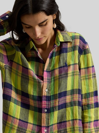 Frauenmodel trägt Regular Fit Hemdbluse aus reinem Leinen von Polo Ralph Lauren mit kariertem Allover-Muster in Grün, Gelb, Rosa und Dunkelblau, Logo-Stitching, Hemdkragen und einreihiger Knopfleiste, Materialstruktur ist leicht und natürlich, Nahaufnahme Oberkörper.