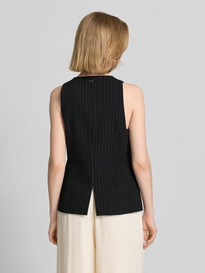 Frauenmodel trägt Slim Fit Weste aus reiner wiskoza Modell 'JULERAN' von BOSS, efekt: wzór w cienkie prążki, rozporek, kieszenie z wypustkami, aplikacja z metką, kolor czarny, materiał gładki, Ganzkörperansicht Rückansicht.