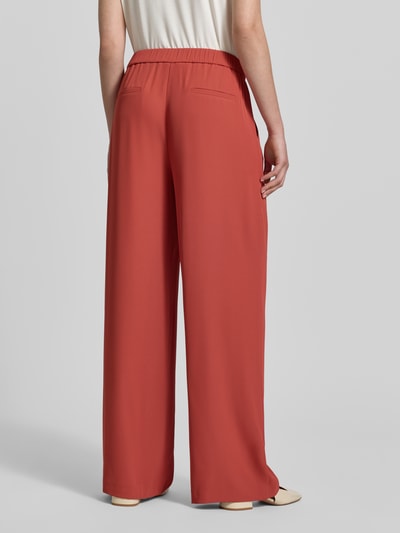 Frauenmodel trägt Hose mit elastischem Bund von Jake*s Collection in Rostrot, Material-Mix mit Stretch, Regular Fit, Gesäßtaschen, Ganzkörperansicht Rückansicht.