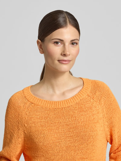 Frauenmodel trägt Pullover mit Rundhalsausschnitt von monari in Orange, Baumwoll-Mix, Gerader-Schnitt, Gerippte-Abschlüsse, Nahaufnahme Oberkörper.