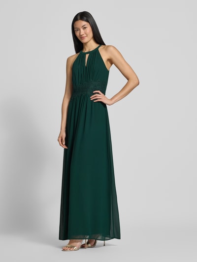 Vrouwenmodel draagt avondjurk met tailleband Model 'MILINA' van VILA, chiffon, getailleerd model, maxi-jurk, halter, druppelvormige hals, tailleband, ruglengte maat 36: 146 cm, borstwijdte maat 36: 35 cm, voorkant volledige lichaamsopname.