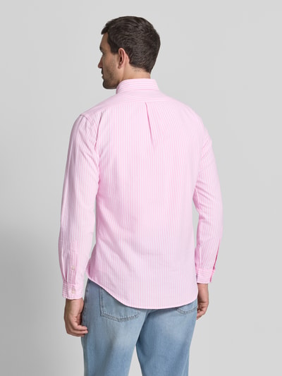 Männermodel trägt Regular Fit Freizeithemd aus reiner Baumwolle von Polo Ralph Lauren in Rosa mit weißen Streifen, Ganzkörperansicht Rückansicht.