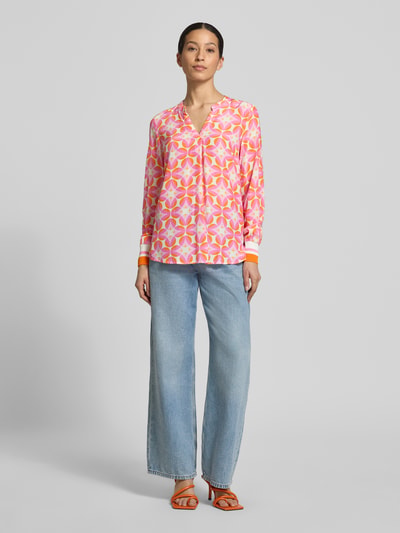 Modelka nosi Regular Fit Bluse aus reiner Viskose od Emily Van den Bergh, tunikowy dekolt, geometryczny wzór, długie rękawy, elastyczne mankiety, wielokolorowa, widok całej sylwetki z przodu.