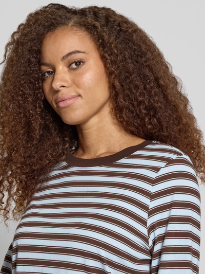 Kobieta modelka nosi niebiesko-brązową, prążkowaną bluzkę z długim rękawem Regular Fit Langarmshirt aus reiner Baumwolle model 'LUNA' od ONLY, damska bluzka z długim rękawem, zbliżenie na górną część ciała.