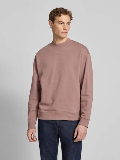 Männermodel trägt Regular Fit Sweatshirt aus reiner Baumwolle Modell 'DAPOCREW' von HUGO, unifarben, Rundhals, Label Print, Ganzkörperansicht von vorne