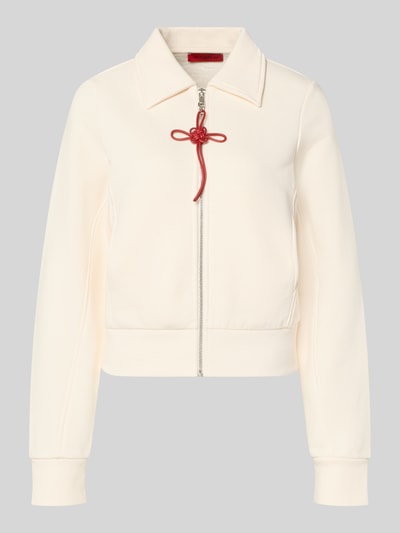Produktfoto, Slim Fit Sweatjacke aus reiner Baumwolle Modell 'EROICO' von MAX&Co., jednolita, kremowa, długi rękaw, kołnierz koszulowy, suwak z czerwoną kokardą, metaliczne akcenty, prążkowane wykończenie, kieszenie boczne, materiał sweat.