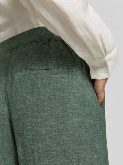 Vrouwenmodel draagt Leinenhose mit Eingrifftaschen Modell 'Pennie Ginia' van MSCH Copenhagen, linnenmix met viscose, wide leg fit, Franse steekzakken, achterzakken, haak- en ritssluiting, detailopname heup en taille.