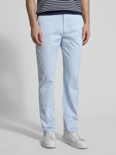 Männermodel trägt Slim Fit Chino aus Baumwoll-Mix von Tommy Hilfiger in Hellblau, unifarben, seitliche Taschen, Ganzkörperansicht von vorne.
