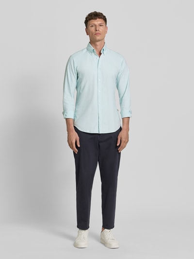 Männermodel trägt Regular Fit Freizeithemd aus reiner Baumwolle Modell 'RICKERT' von BOSS Orange in Hellblau, Ganzkörperansicht von vorne.
