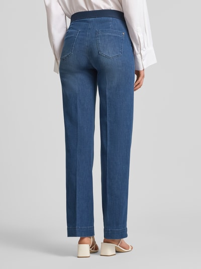 Frauenmodel trägt Damen Wide Leg Jeans mit Eingrifftaschen Modell 'Jenny' von TONI, blaue Baumwoll-Lyocell-Mischung in ausgestelltem Schnitt, mit elastischem Bund, Knopf-, Reißverschluss und Gesäßtaschen, Ganzkörperansicht Rückansicht.