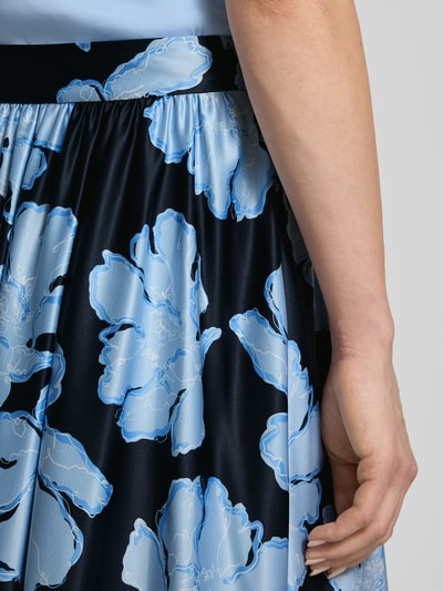 Kobiece model prezentuje spódnica midi z elastycznym pasem od Christian Berg Cocktail, satyna, linia a, szerokość w rozmiarze 36: 38 cm, całkowita długość w rozmiarze 36: 84 cm, zbliżenie na górną część.