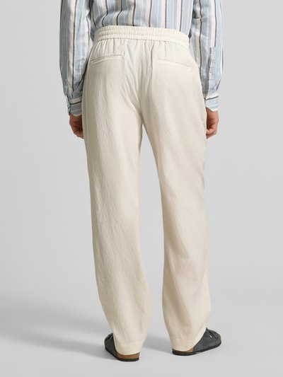 Männermodel trägt Relaxed Fit Hose mit elastischem Bund Modell 'ELLIOT' von Antony Morato aus Viskose-Mix mit Leinen-Anteil, Ganzkörperansicht Rückansicht.