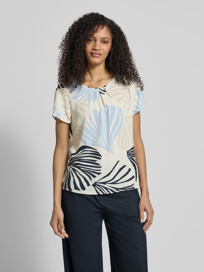 Frauenmodel trägt Loose Fit Blusenshirt mit Allover-Muster von s.Oliver BLACK LABEL in Creme, Blau und Schwarz, Chiffon, Nahaufnahme Oberkörper.