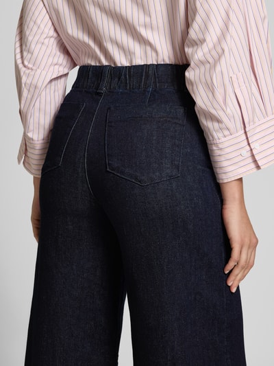 Frauenmodel trägt Wide Leg Jeans mit Eingrifftaschen von Stefanel, dunkelblauer Baumwoll-Elasthan-Mix, Detailaufnahme Rückansicht.
