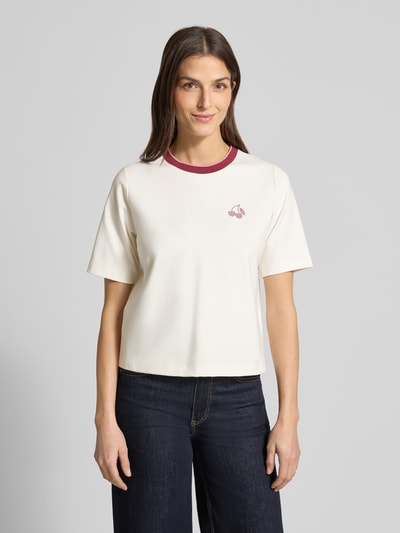 Frauenmodel trägt Regular Fit T-Shirt mit Strasssteinbesatz von Marc Cain, cremefarben, Rundhalsausschnitt, Ganzkörperansicht von vorne.