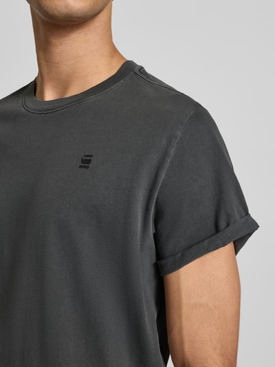 Męski t-shirt z bawełny w kolorze ciemnoszarym, nadruk z logo, krój regular fit, model 'Lash' od G-Star Raw, okrągły dekolt, długość tyłu 76 cm w rozmiarze M. Nahaufnahme Oberkörper.