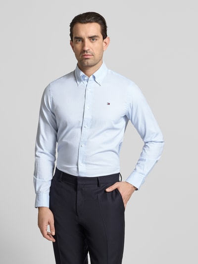 Männermodel trägt Regular Fit Freizeithemd aus reiner Baumwolle von Tommy Hilfiger, Optik: Unifarben, Nahaufnahme Oberkörper.