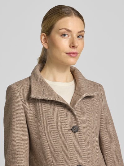 Frauenmodel trägt Regular Fit Mantel aus Woll-Mix von FUCHS SCHMITT in Beige mit Fischgrätmuster, Knopfleiste, Nahaufnahme Oberkörper. Rückenlänge 84 cm, Schulterbreite 41 cm, Brustweite 47 cm, Ärmellänge 67 cm.