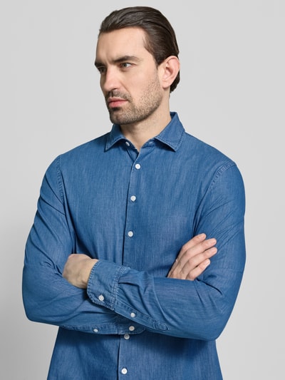 Männermodel trägt Regular Fit Freizeithemd in Denim-Optik mit Kentkragen von MAERZ Muenchen, reine Baumwolle, Nahaufnahme Oberkörper.