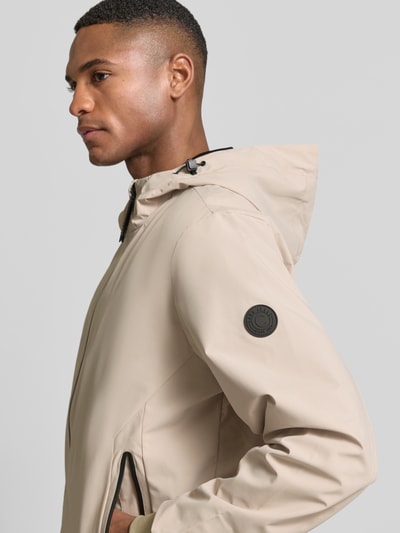 Mannenmodel draagt Jacke mit Reißverschlusstaschen Modell 'MATTEO' van CARS JEANS in beige, regular fit, materiaal-mix met stretch, capuchon met tunnelkoord, rits en ritszakken, detailopname bovenlichaam.