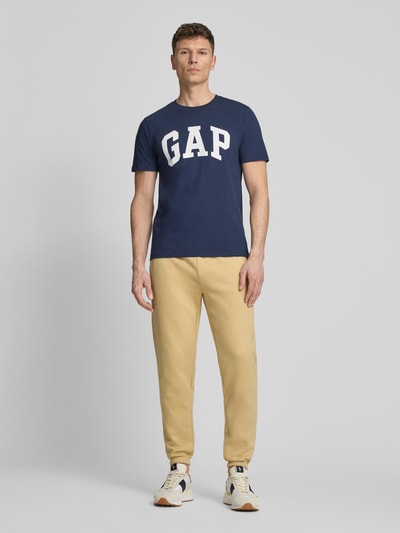 Męski model nosi Sweatpants mit elastischem Bund od GAP, bawełniany miks, krój regular fit, tylna kieszeń, długość nogawki 74 cm, zdjęcie całej sylwetki z przodu.