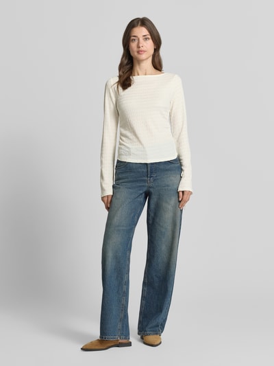 Frauenmodel trägt Regular Fit Langarmshirt mit Binde-Detail Modell 'HAZEL' von Vero Moda, Optik: Unifarben, Struktur-Muster, Raffung, U-Boot-Ausschnitt, Trompetenärmel, Ganzkörperansicht von vorne.