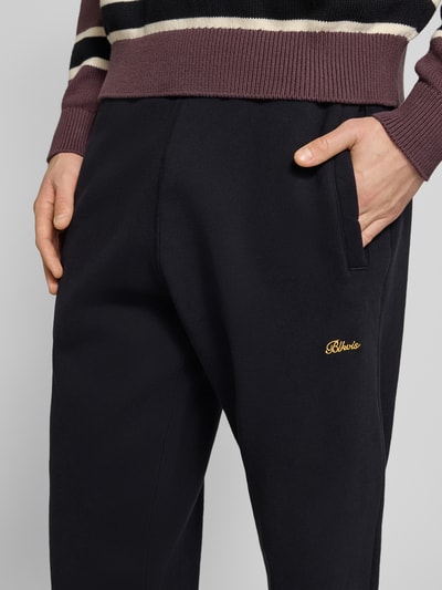 Männermodel trägt schwarze Sweatpants mit elastischem Bund Modell 'Script' von BLKVIS aus reiner Baumwolle, Relaxed-Fit, Nahaufnahme Oberkörper.