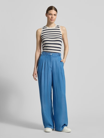 Frauenmodel trägt Wide Fit Hose aus Lyocell mit Gesäßtaschen von Smith & Soul, reine Lyocell, blaue Farbe, Gelegte Falten, Ganzkörperansicht von vorne.
