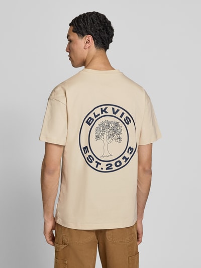 Mannelijk model draagt T-shirt met Logo en ronde hals van BLKVIS, beige, puur katoen, regular fit, grote print achterzijde, ruglengte maat M 70 cm, totaalbeeld achteraan