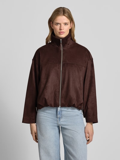 Frauenmodel trägt Jacke in Leder-Optik mit Reißverschluss und Eingrifftaschen von Gina Tricot, Material-Mix mit Stretch-Anteil, Relaxed-Fit, braun, glatte Struktur, Ganzkörperansicht von vorne.