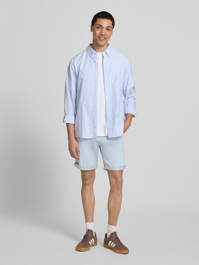 Männermodel trägt Regular Fit Shorts mit Eingrifftaschen Modell 'BOWIE' von Jack & Jones aus Baumwoll-Elasthan-Mix, hellblau, Umschlag, Ganzkörperansicht von vorne.