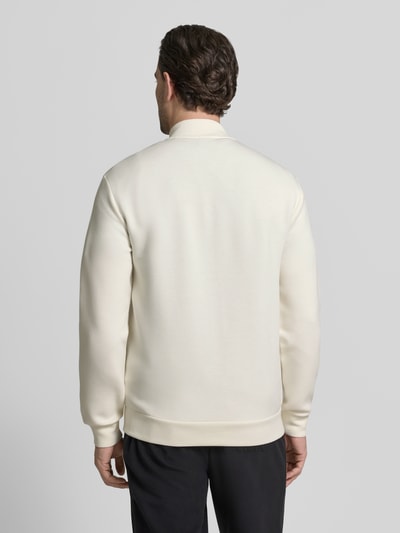 Männermodel trägt Sweatjacke mit Reißverschluss von EA7 Emporio Armani in Creme, gerippte Abschlüsse, Rückenansicht, Ganzkörperansicht Rückansicht.