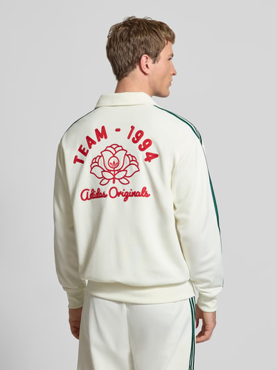 Männermodel trägt Sweatjacke mit Logo-Stitching und Stehkragen von adidas Originals, Material-Mix, Gerader-Schnitt, Rückenansicht.